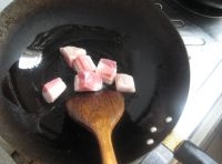 鍋里倒油把五花肉的皮朝下放入鍋中，用小火煎出油后倒出；