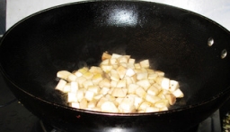 炒鍋中加入適量的油燒熱，放入切丁杏鮑菇煸炒，用小火把鍋中杏鮑菇的水分煸出來；
