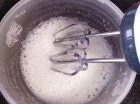 蛋清打成魚眼泡後放點糖繼續攪拌，分三次放入糖攪拌；